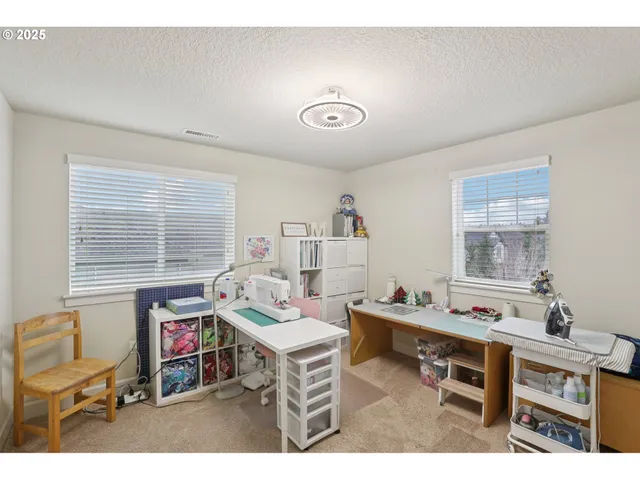 a living room with furniture a window and a flat screen tv