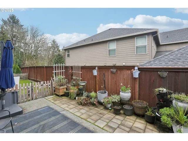 a view of a chairs and table in backyard