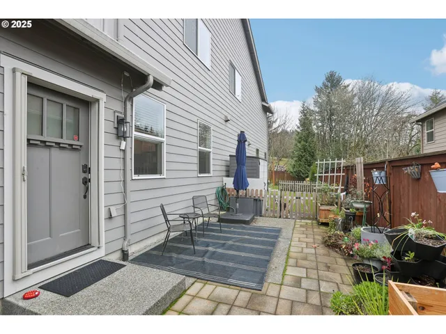 a view of a patio with table and chairs and potted plants