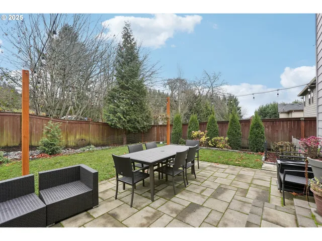 a view of a yard with furniture and a garden