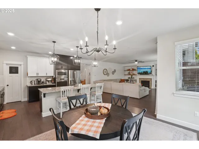 a large kitchen with a table and chairs