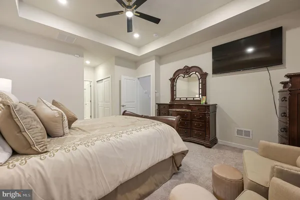 a bedroom with a bed and a television