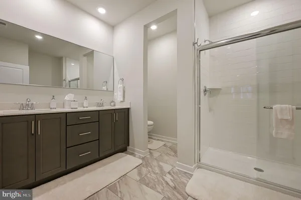 a bathroom with a granite countertop sink mirror and shower
