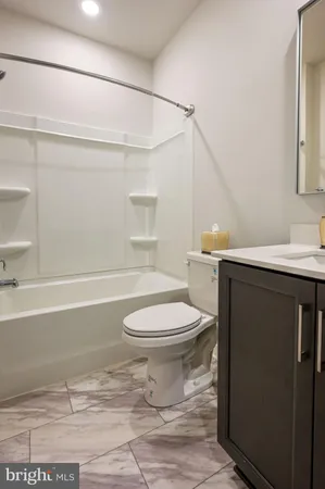 a bathroom with a toilet a sink and bathtub