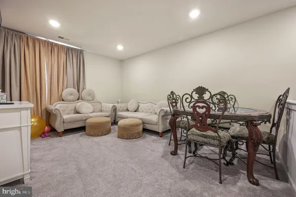 a view of a livingroom with furniture and a large window