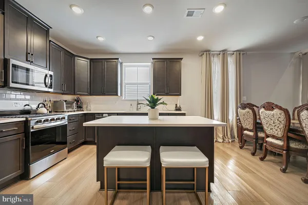 a kitchen with a table chairs stove and cabinets
