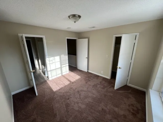 a view of entryway with window and wooden floor