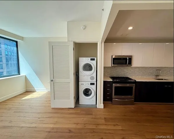 a view of a kitchen with a sink and cabinets