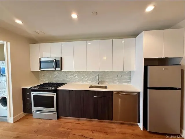 a kitchen with a sink and a refrigerator