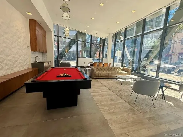 a living room with patio furniture and a fireplace