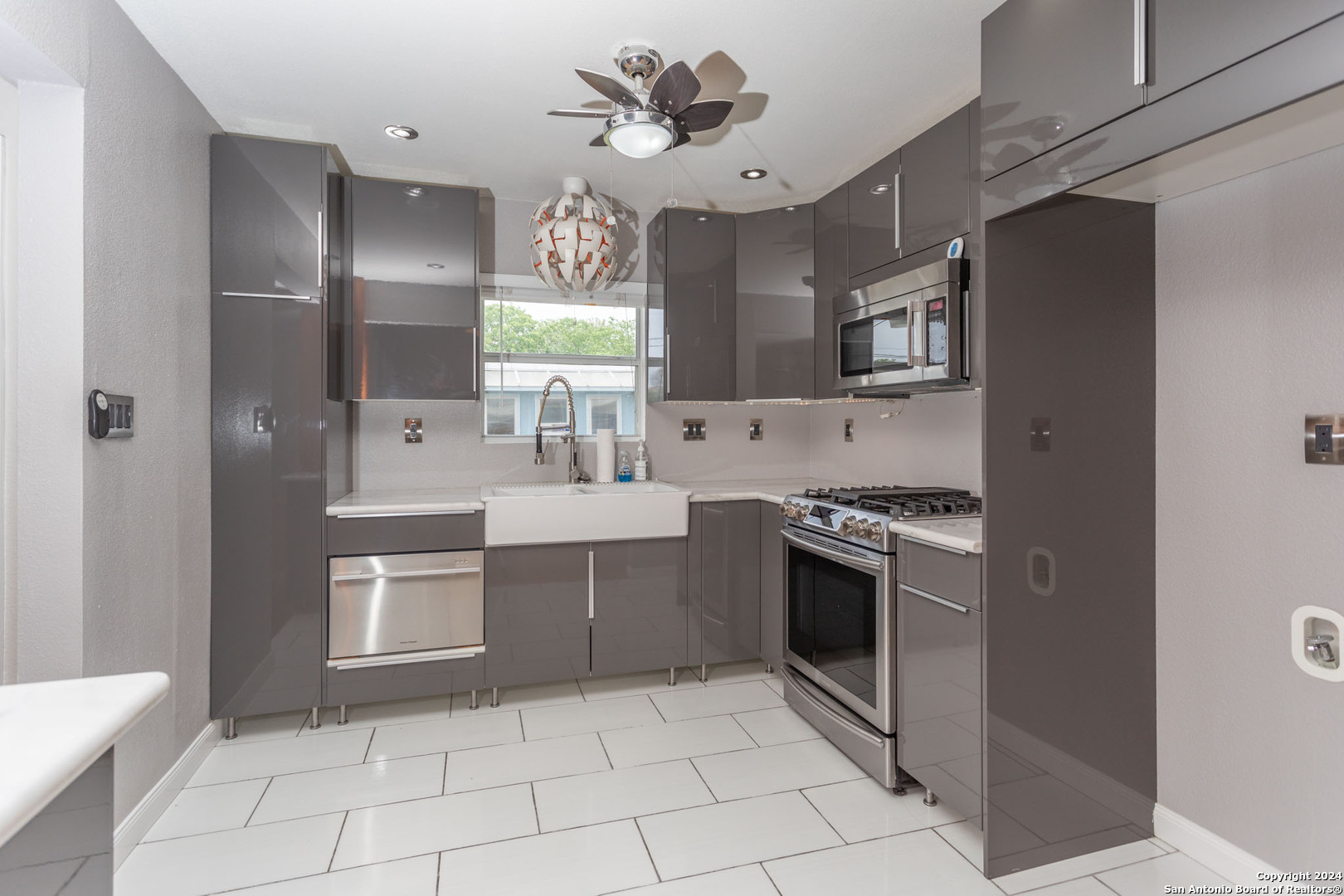 229 Weathercock Lane Windcrest, TX 78239 - Photo 5 of 12 a kitchen with stainless steel appliances a sink stove and cabinets