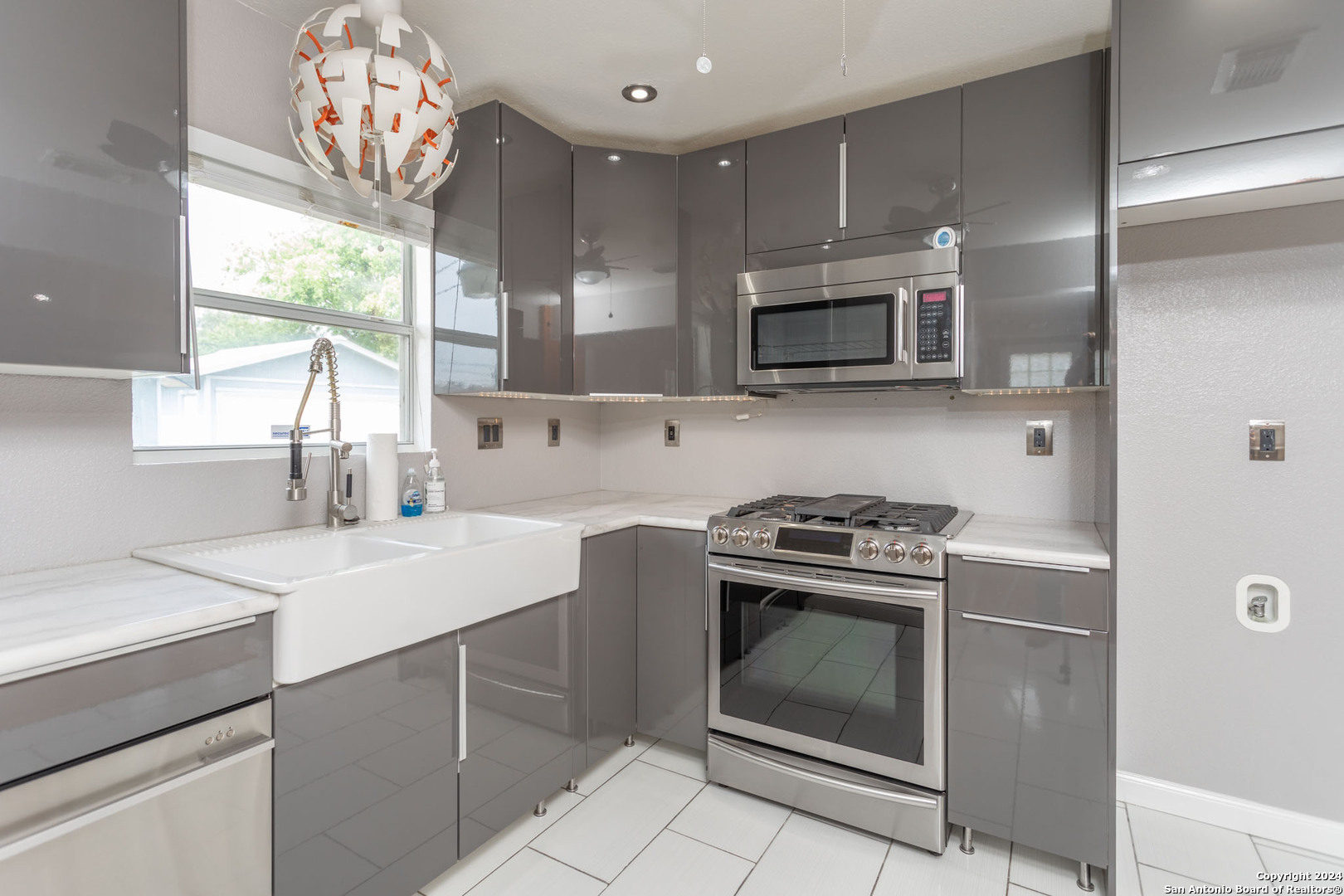 229 Weathercock Lane Windcrest, TX 78239 - Photo 6 of 12 a kitchen with stainless steel appliances a stove a sink and a microwave
