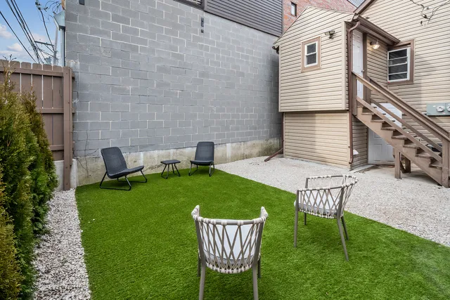 a view of a chair and table in the backyard
