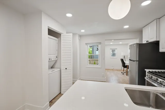 a kitchen with stainless steel appliances a refrigerator and a sink