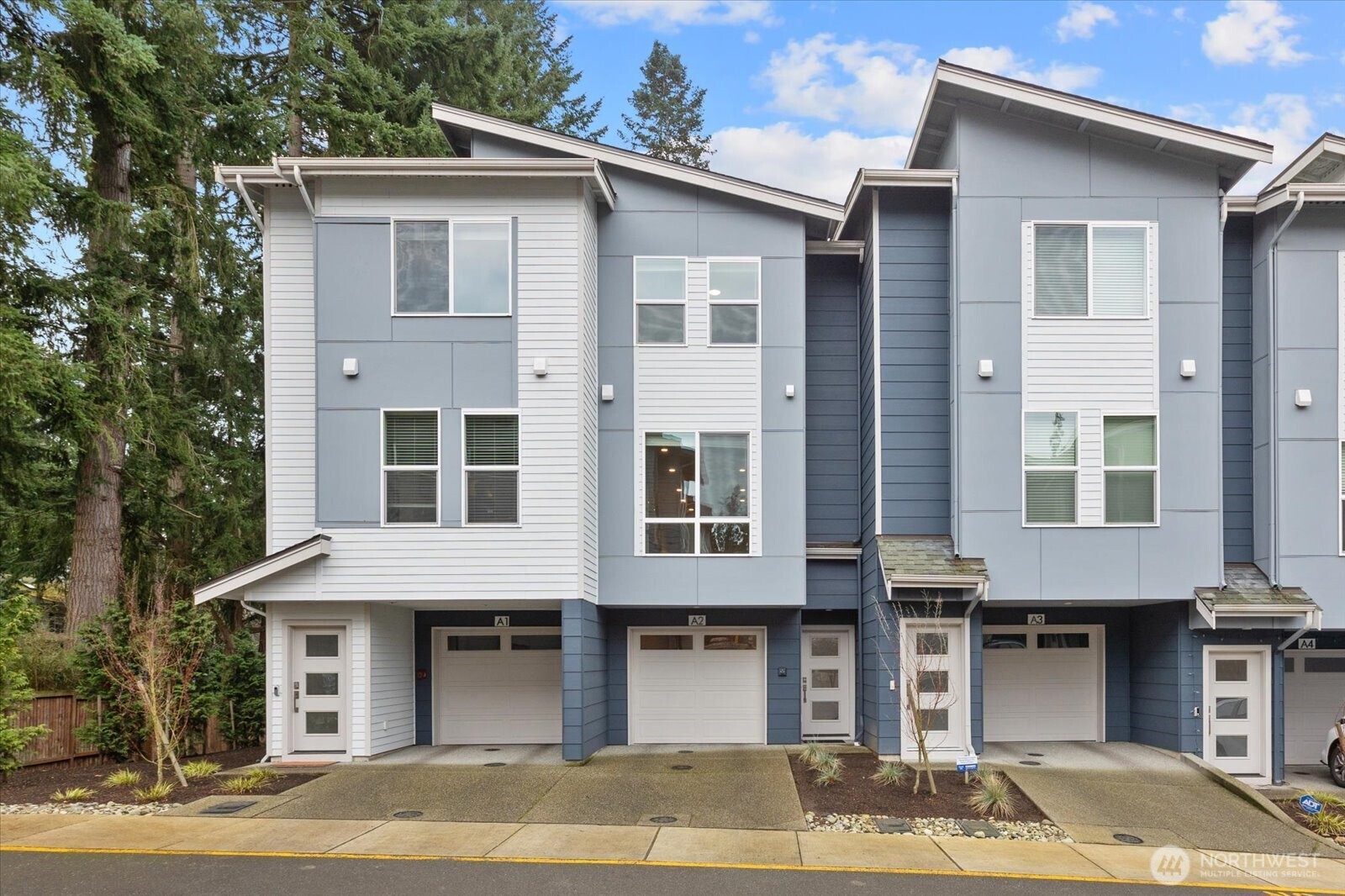 23413 Edmonds Way, Unit A2 Edmonds, WA 98026 - Photo 3 of 40 a front view of a residential apartment building with a yard