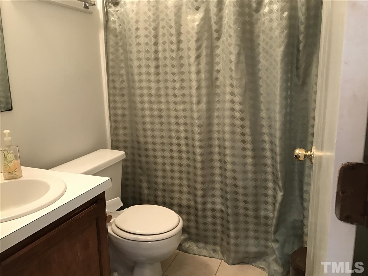 8205 Wynewood Drive Raleigh, NC 27616 - Photo 16 of 24 a bathroom with a sink and a toilet