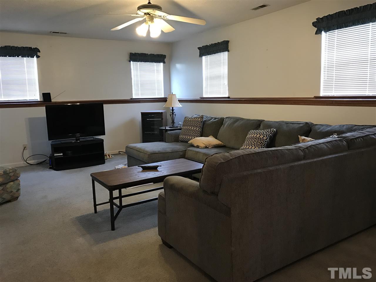 8205 Wynewood Drive Raleigh, NC 27616 - Photo 18 of 24 a living room with furniture and a flat screen tv
