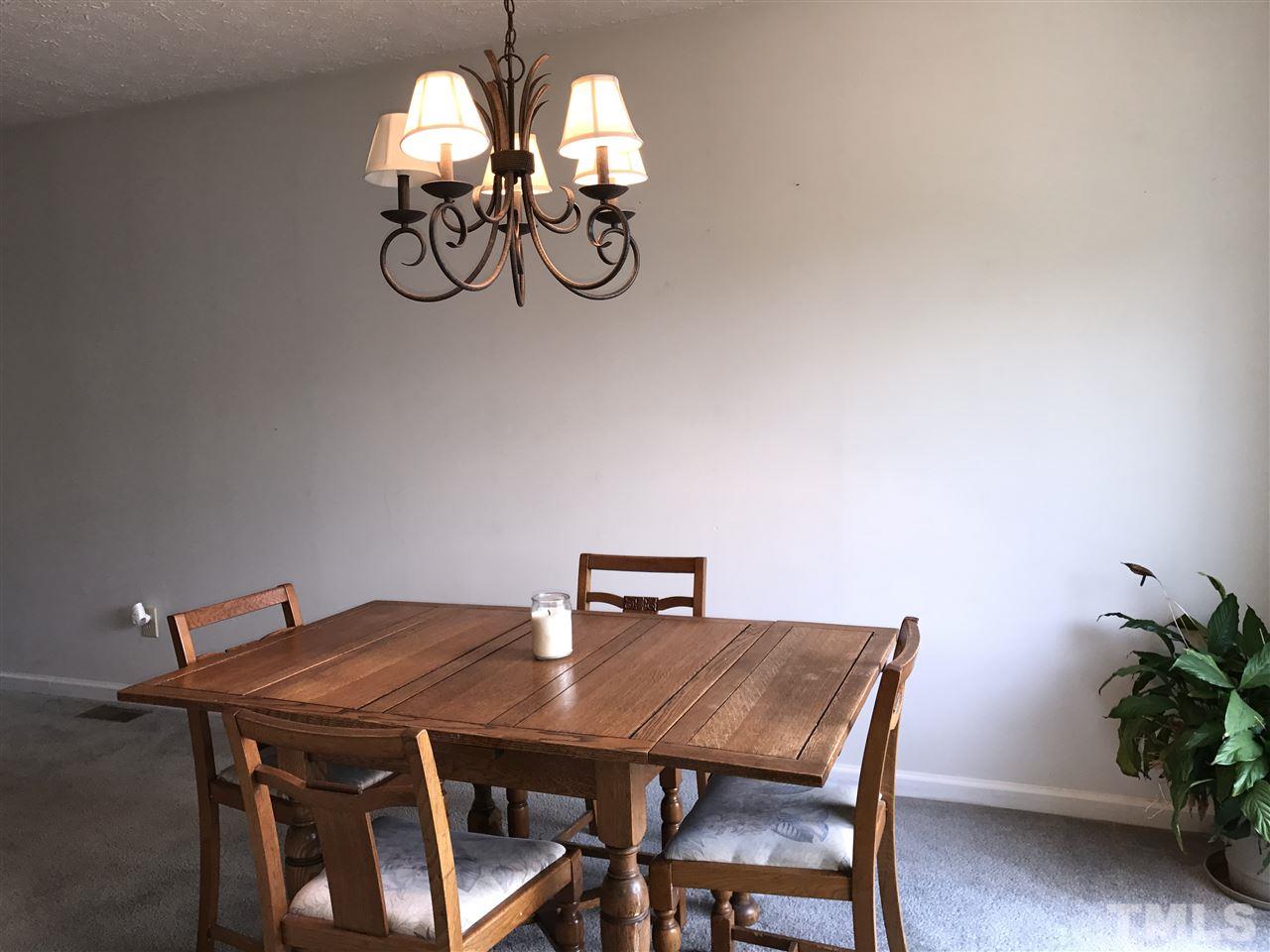 8205 Wynewood Drive Raleigh, NC 27616 - Photo 6 of 24 a view of a dining room with a table and chairs