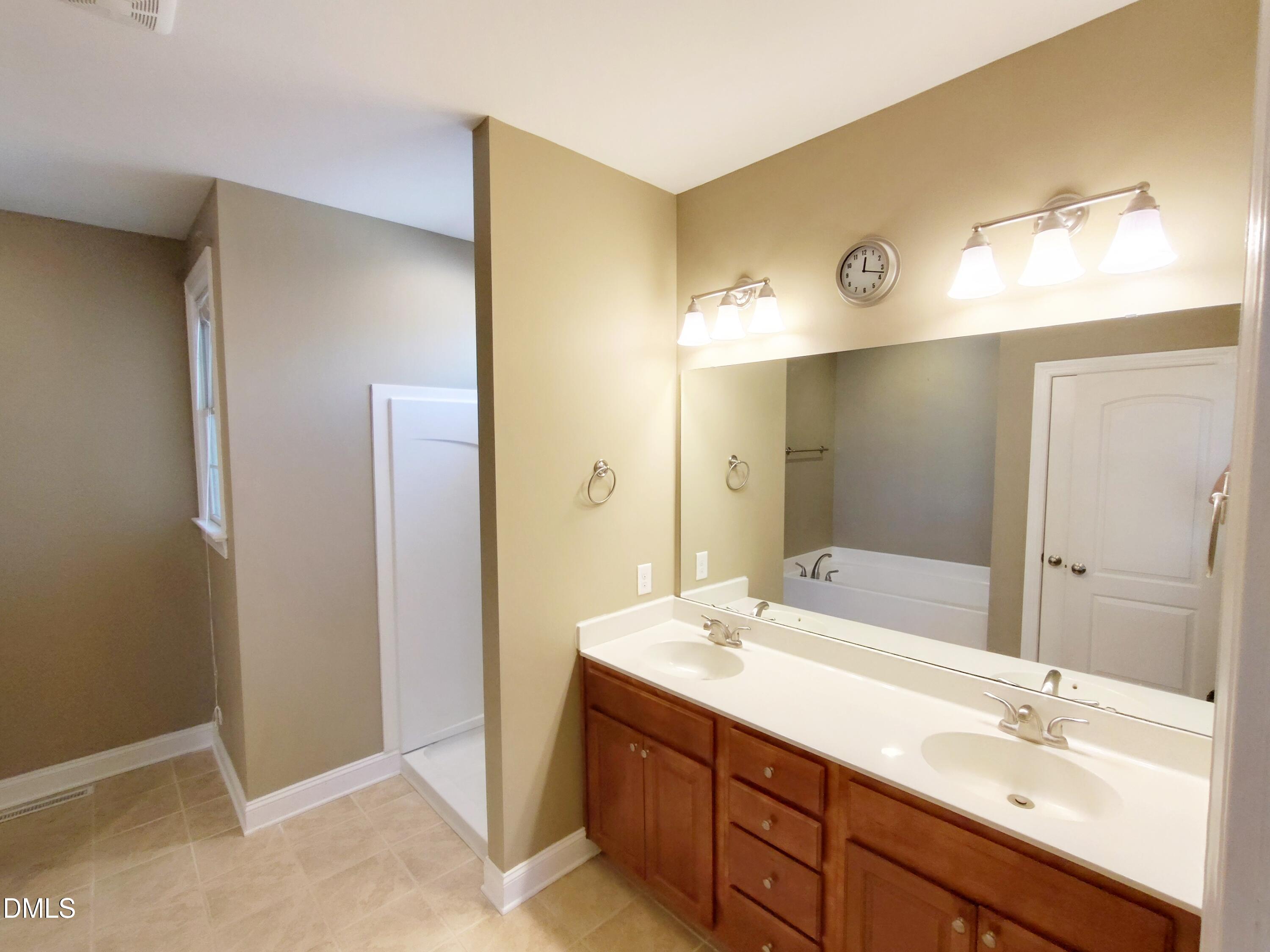 279 Weaver Ridge Road Rougemont, NC 27572 - Photo 13 of 25 a bathroom with a double vanity sink mirror and double