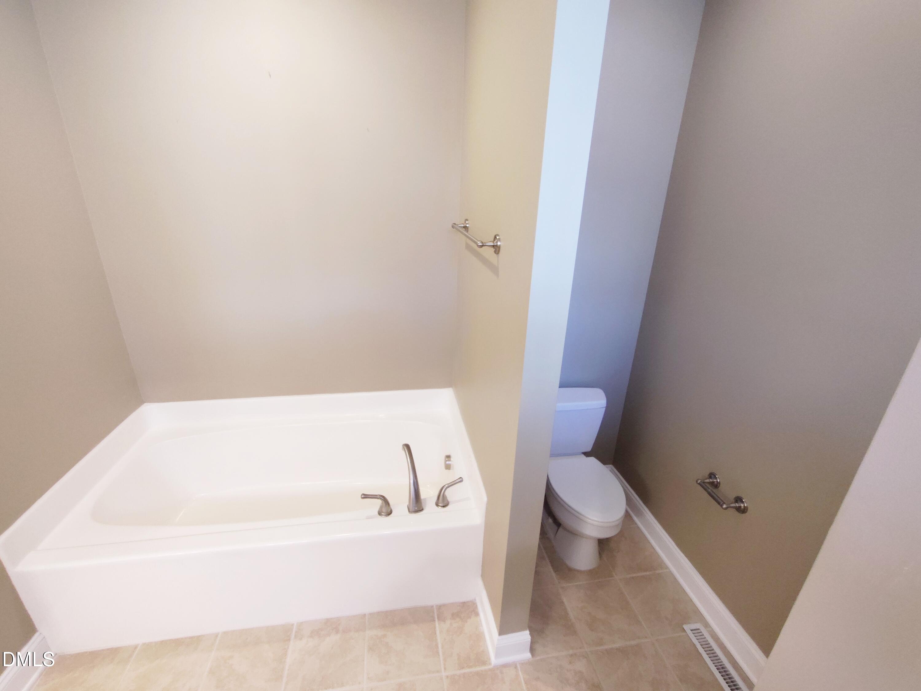 279 Weaver Ridge Road Rougemont, NC 27572 - Photo 15 of 25 a white bath tub sitting next to a white toilet
