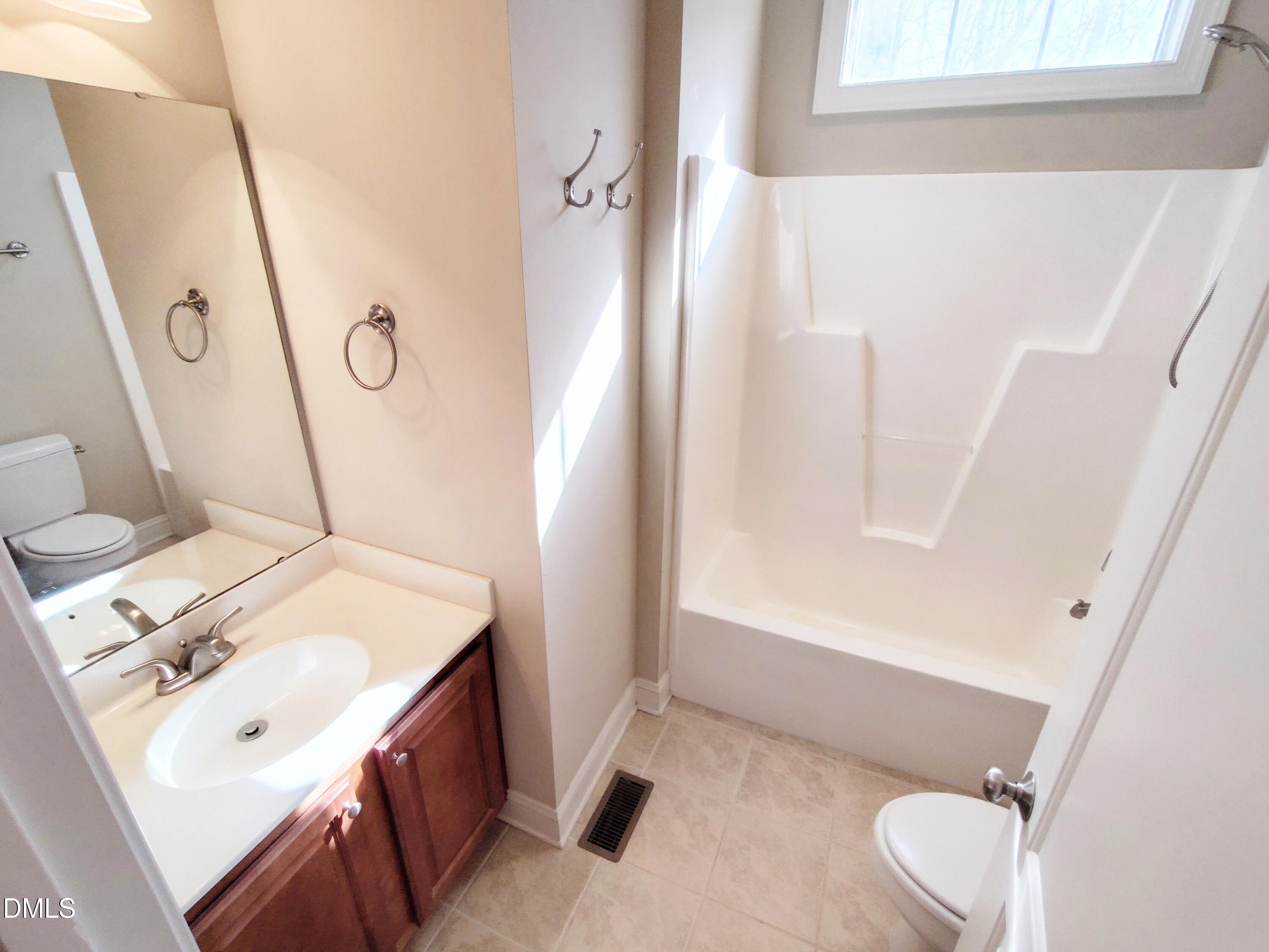 279 Weaver Ridge Road Rougemont, NC 27572 - Photo 18 of 25 a bathroom with a sink a toilet and shower