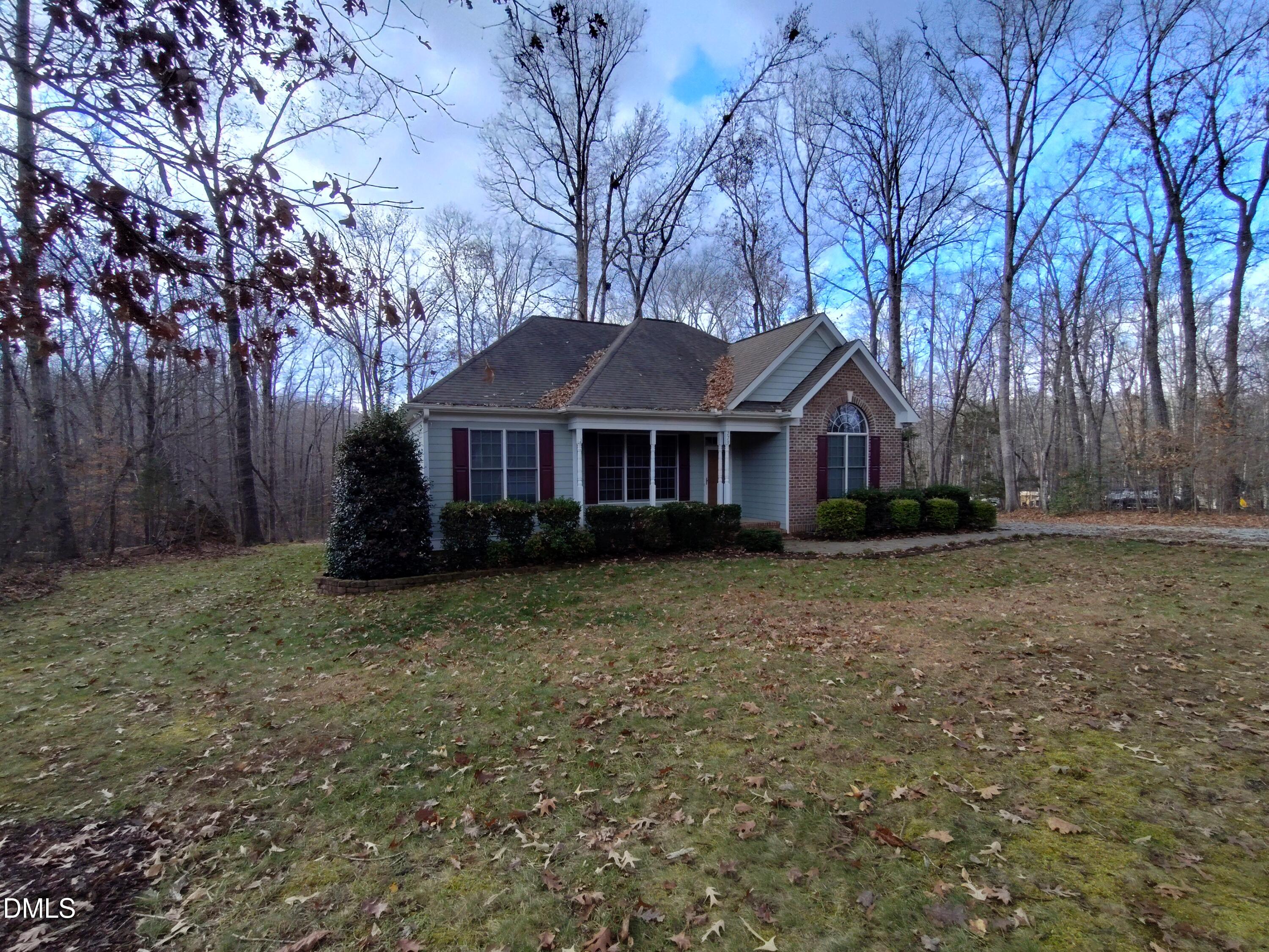 279 Weaver Ridge Road Rougemont, NC 27572 - Photo 3 of 25 a front view of a house with a yard