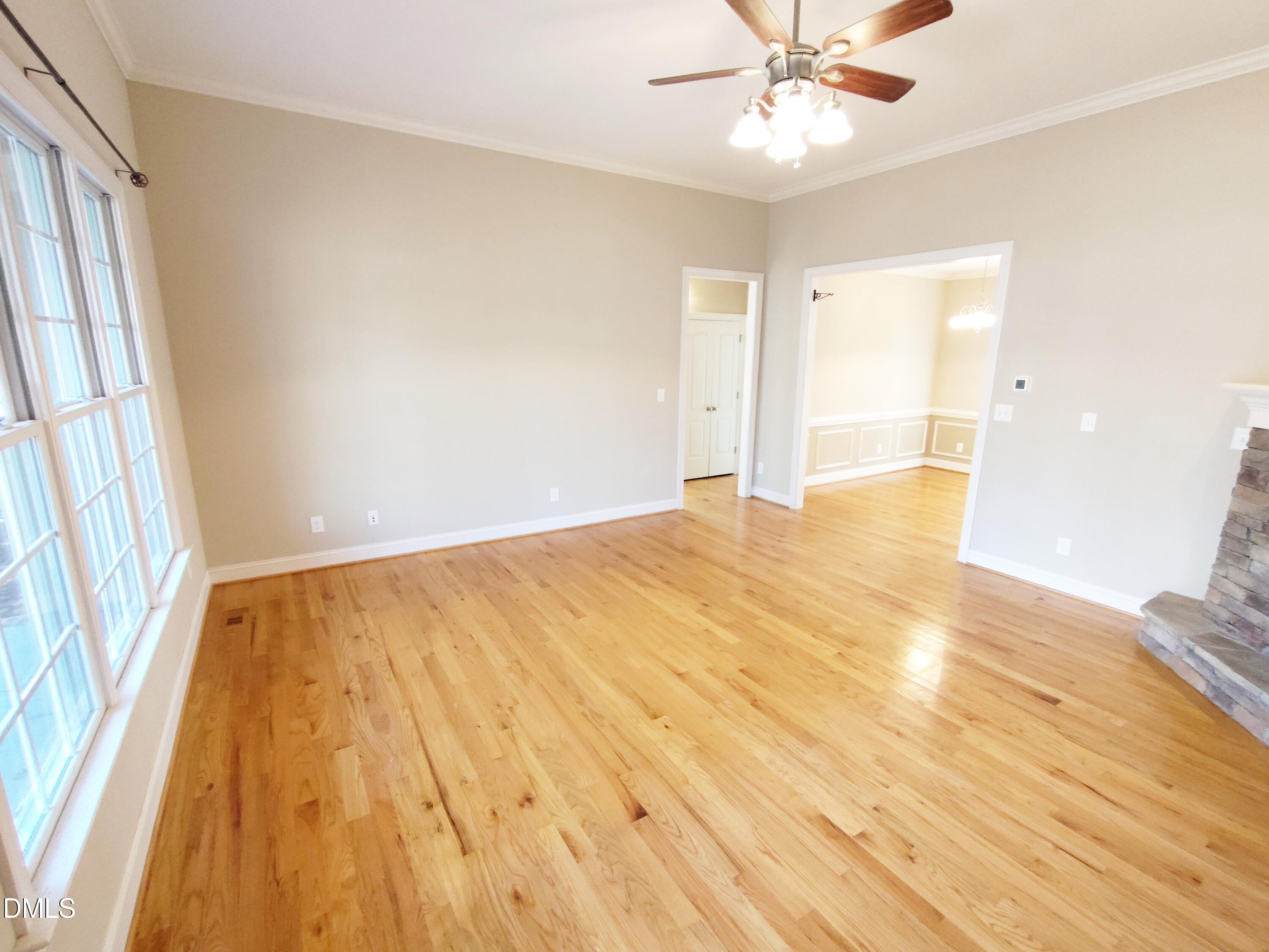 279 Weaver Ridge Road Rougemont, NC 27572 - Photo 5 of 25 an empty room with wooden floor and windows