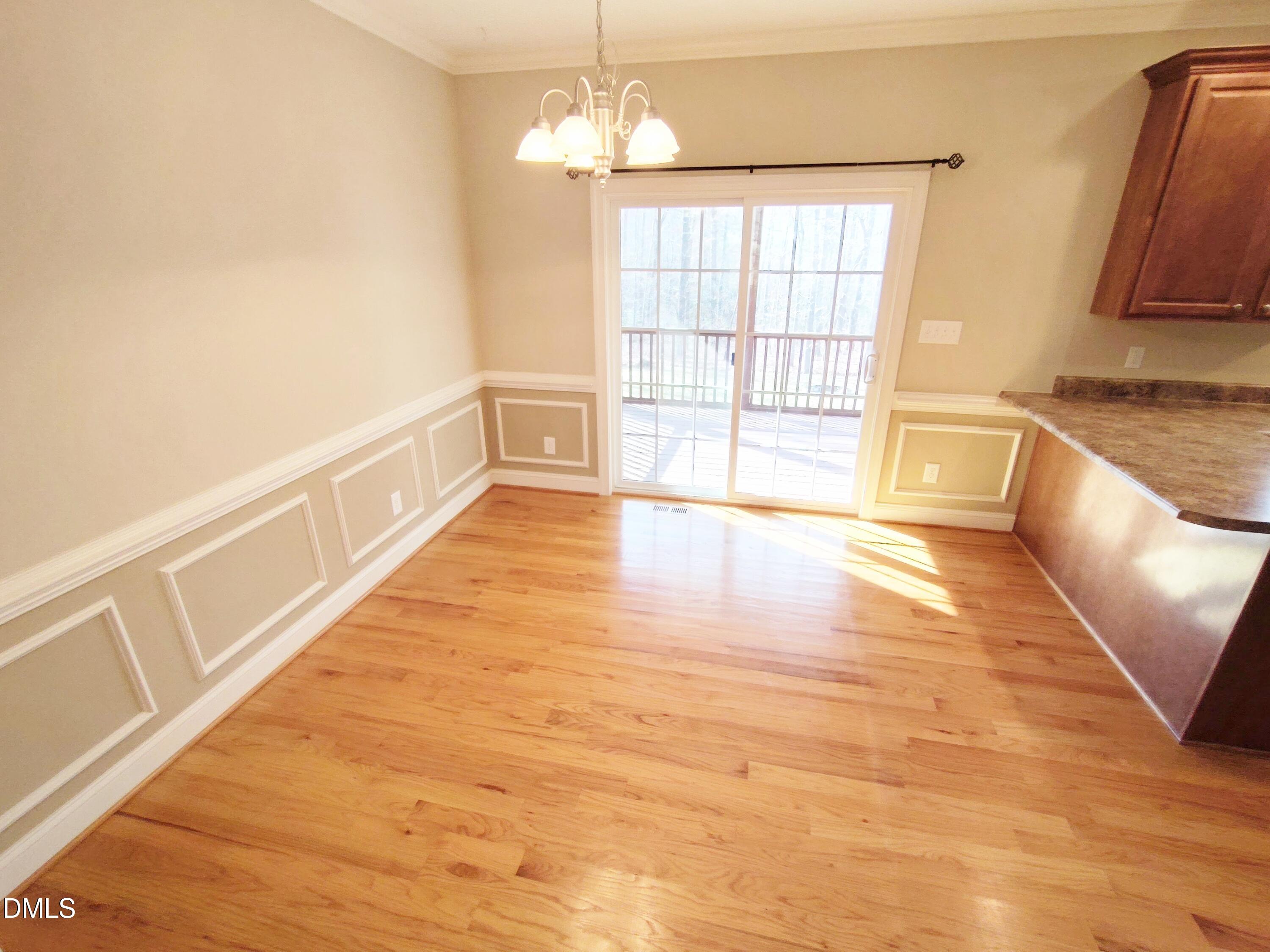 279 Weaver Ridge Road Rougemont, NC 27572 - Photo 6 of 25 a view of an empty room with wooden floor and a window