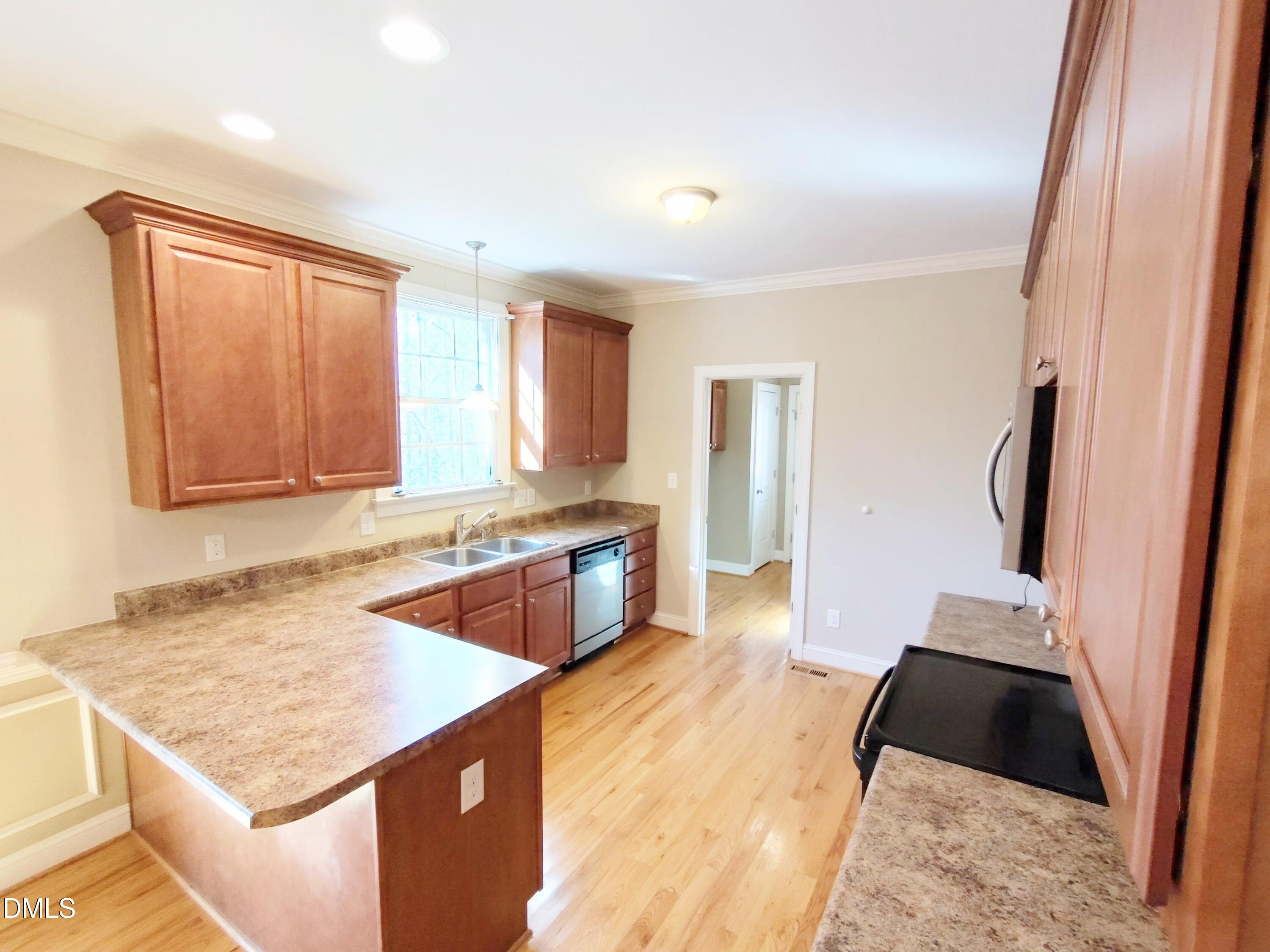 279 Weaver Ridge Road Rougemont, NC 27572 - Photo 7 of 25 a kitchen with granite countertop a sink stove and refrigerator