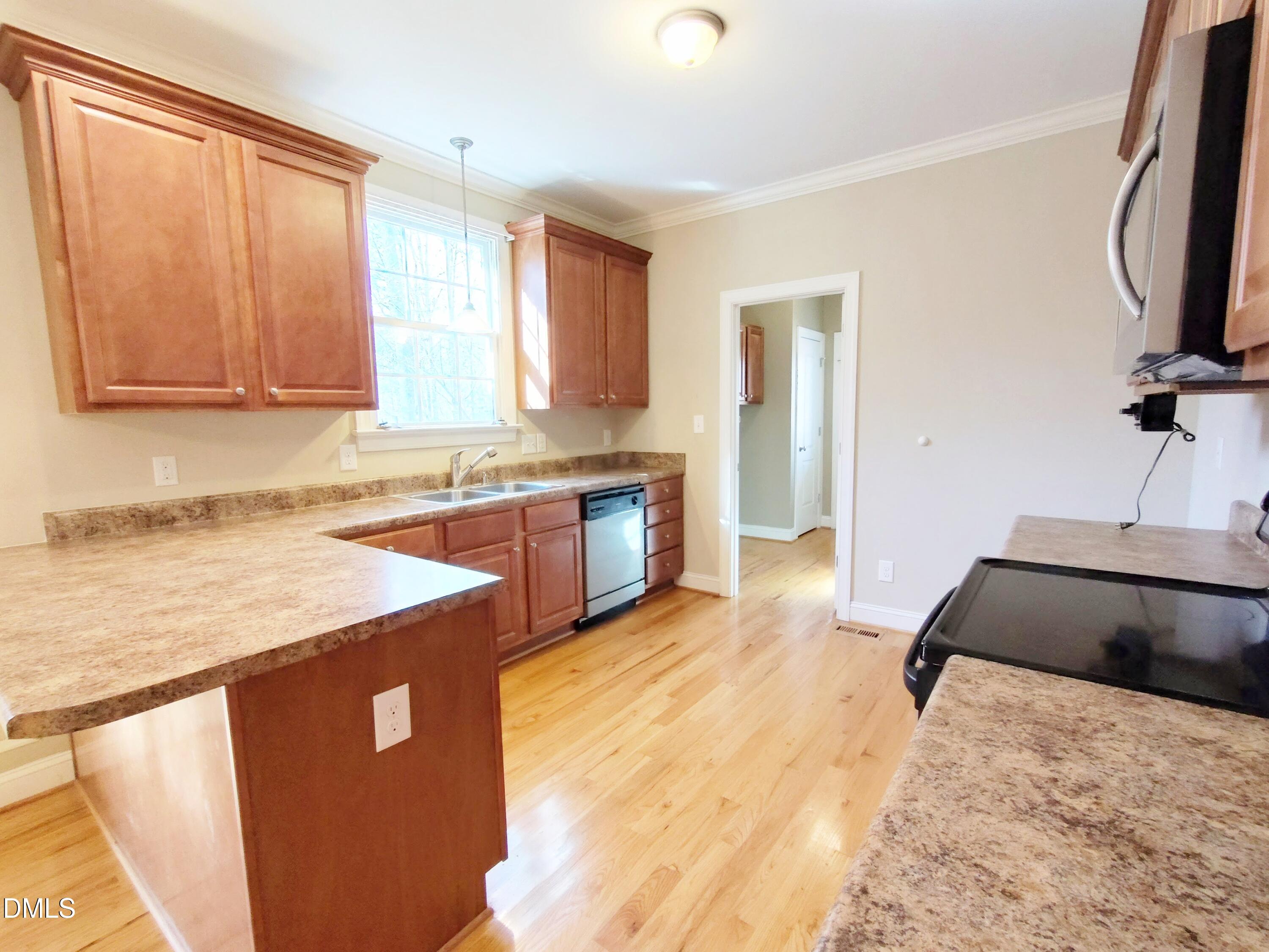 279 Weaver Ridge Road Rougemont, NC 27572 - Photo 8 of 25 a kitchen with a stove a sink and a refrigerator
