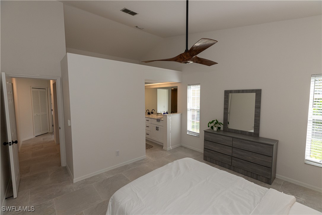 2170 Faliron Road North Fort Myers, FL 33917 - Photo 13 of 30 a bedroom with a bed and a chandelier