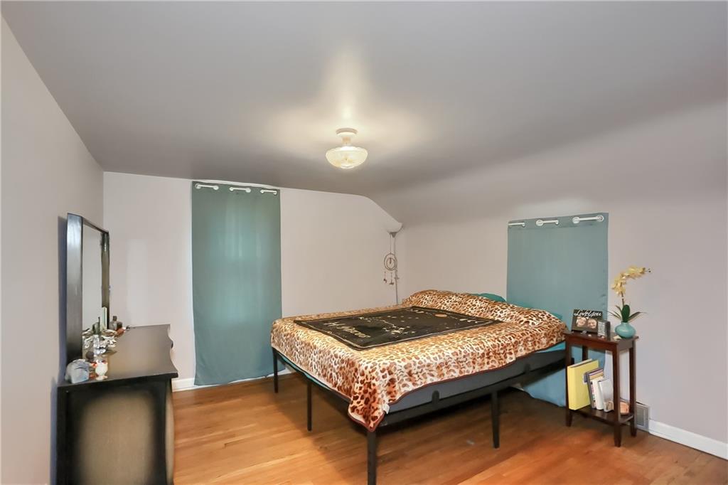 3564 Ellwood Road New Castle, PA 16101 - Photo 16 of 34 a bedroom with a bed and a table in it