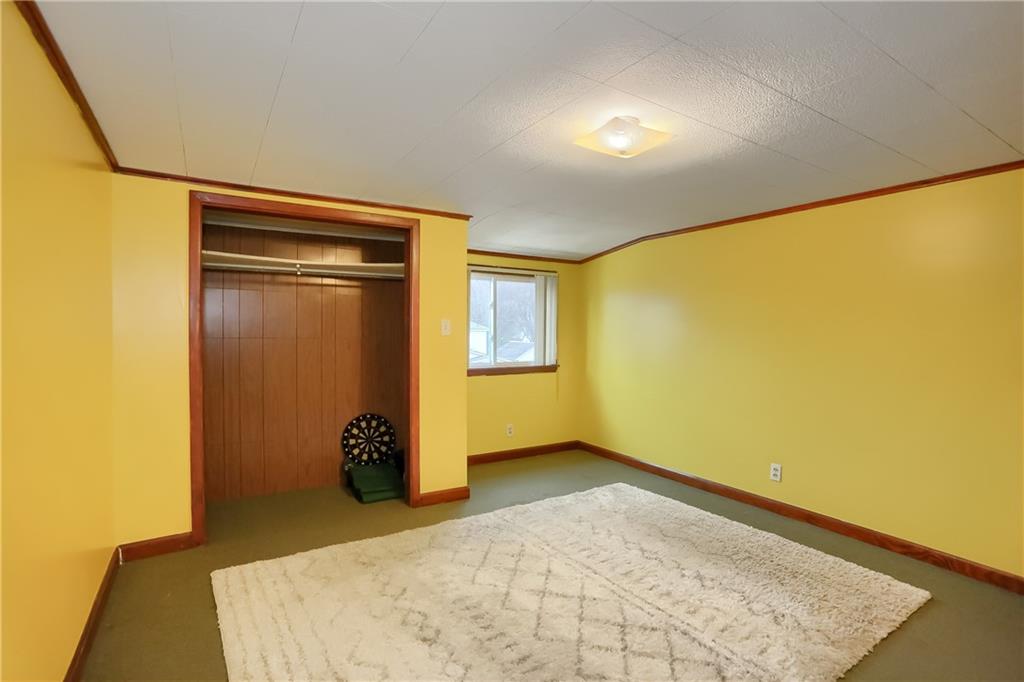 3564 Ellwood Road New Castle, PA 16101 - Photo 21 of 34 a view of an empty room with wooden floor and a window