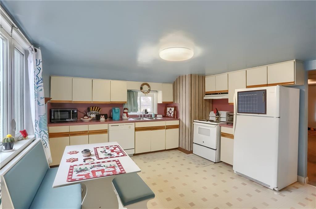 3564 Ellwood Road New Castle, PA 16101 - Photo 7 of 34 a kitchen with a refrigerator and a sink