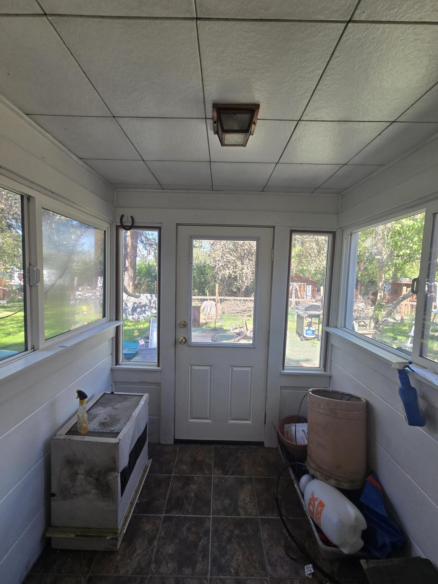 409 East Ash Street Chiloquin, OR 97624 - Photo 3 of 37 a living room with furniture and a floor to ceiling window