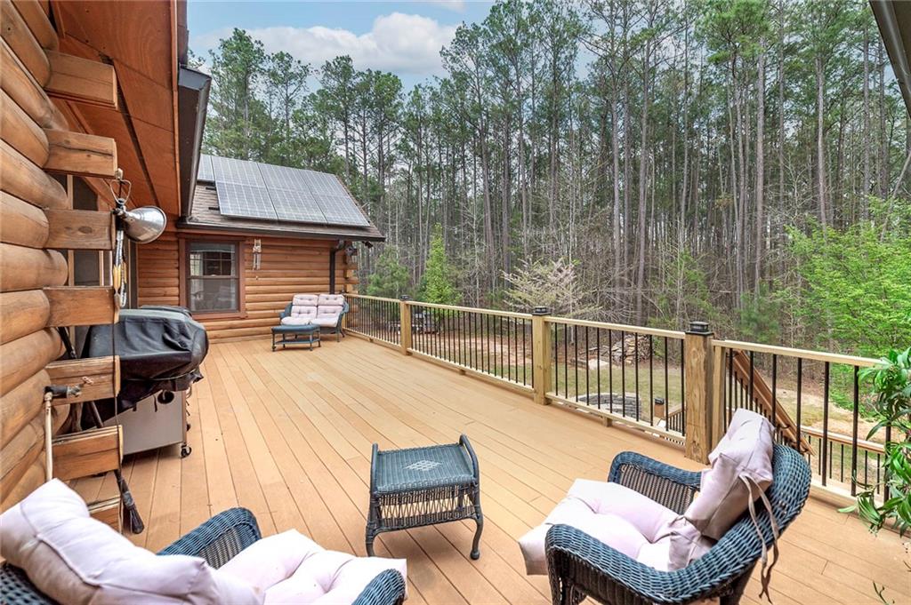 570 Eskew Road McDonough, GA 30252 - Photo 23 of 89 a view of a roof deck with couches chairs and wooden floor