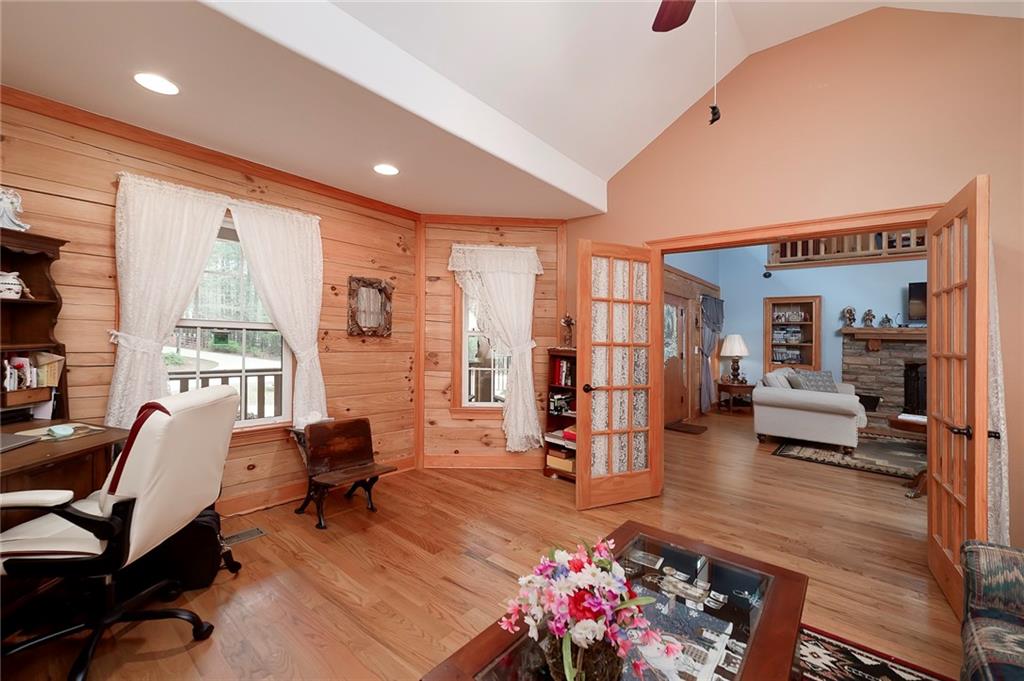570 Eskew Road McDonough, GA 30252 - Photo 30 of 89 a living room with furniture gym equipment and a large window