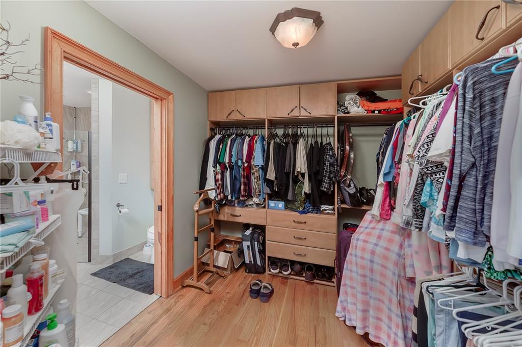 570 Eskew Road McDonough, GA 30252 - Photo 42 of 89 a view of walk in closet with clothes and shoes