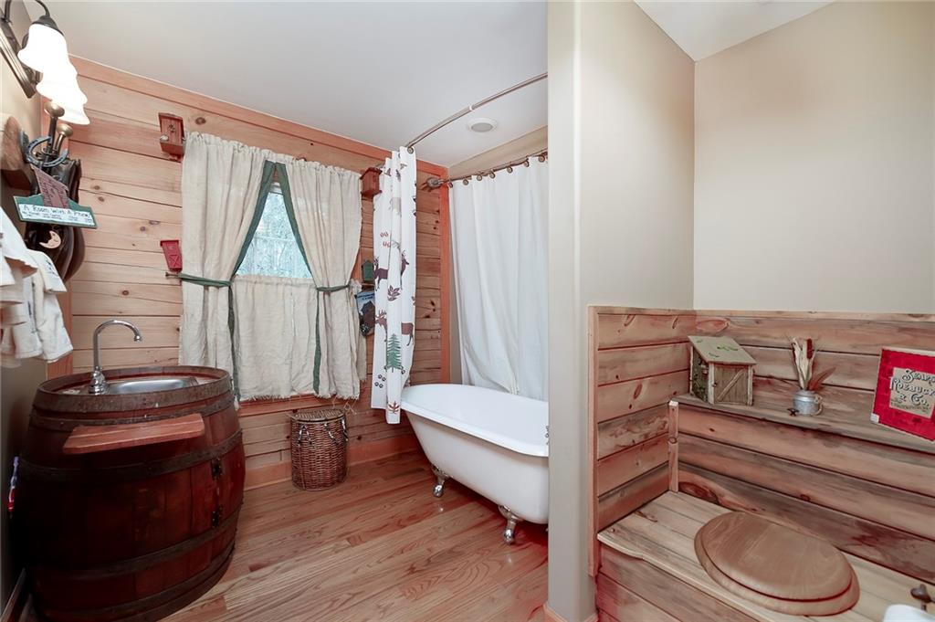 570 Eskew Road McDonough, GA 30252 - Photo 45 of 89 a living room with furniture and a wooden floor