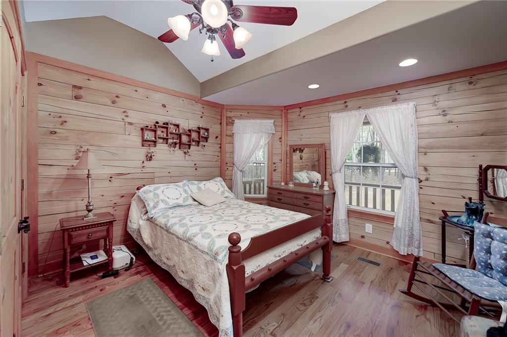 570 Eskew Road McDonough, GA 30252 - Photo 47 of 89 a bedroom with a bed a chandelier and dresser