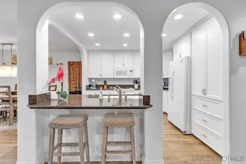 a kitchen with stainless steel appliances granite countertop a kitchen island and cabinets