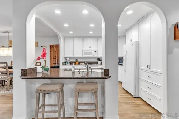 a kitchen with stainless steel appliances granite countertop a kitchen island and cabinets