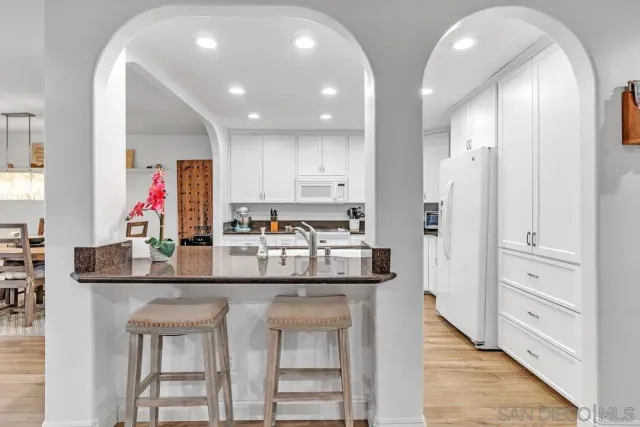 a kitchen with stainless steel appliances granite countertop a kitchen island and cabinets
