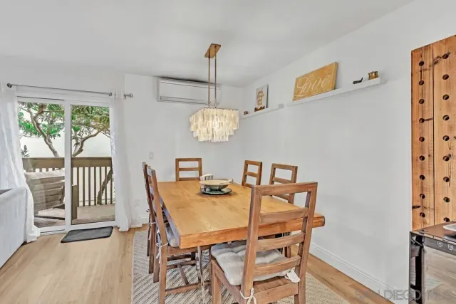 a view of a dining room with furniture wooden floor and a chandelier