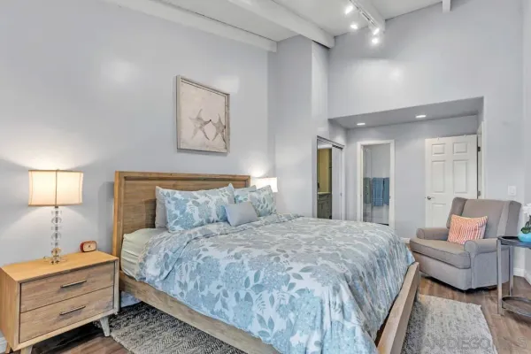 a bedroom with a bed and a couch