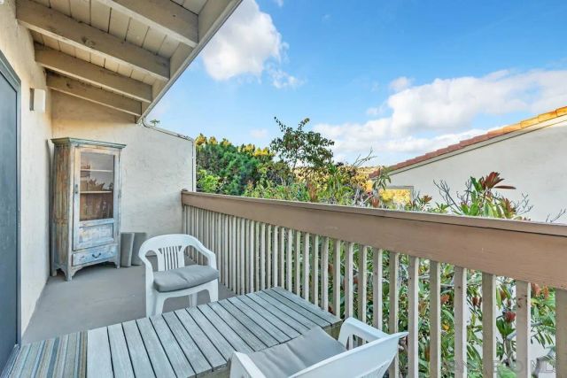 a view of balcony with wooden floor