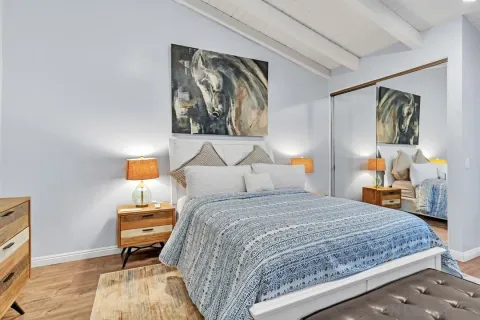 a bedroom with a bed and wooden floor