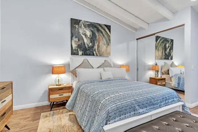 a bedroom with a bed and wooden floor