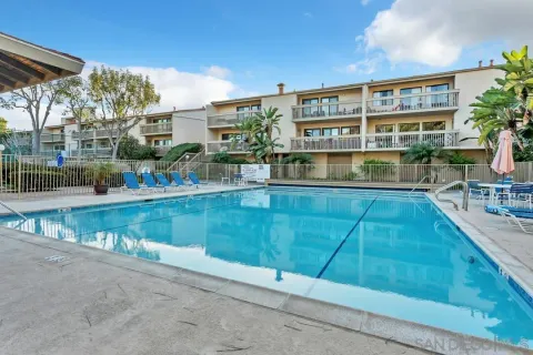 a view of a tennis ground with large trees