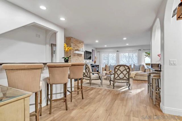 a living room with furniture a wooden floor and a sink
